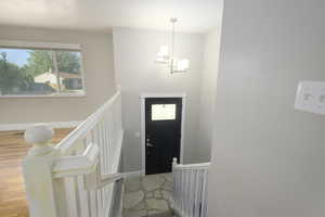 Foyer with baseboards and light wood-style flooring