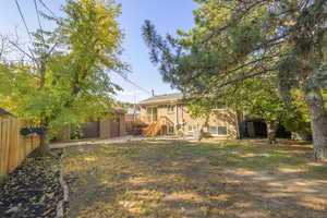 View of yard with stairs, an outbuilding, and a wooden deck
