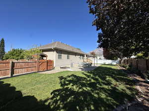 Back of property featuring a patio area, a fenced backyard, and a gate