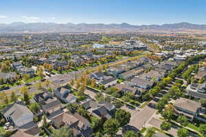 Aerial view of property's location featuring mountains and nearby suburban area