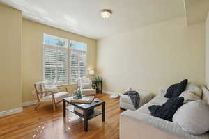 Living area featuring light wood-type flooring and baseboards