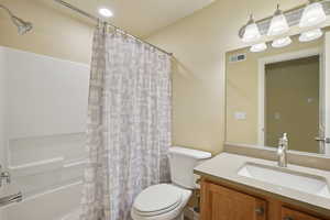 Full bathroom with shower / bathtub combination with curtain and vanity