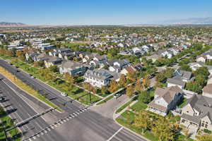 Aerial view of property and surrounding area with a mountain backdrop and nearby suburban area