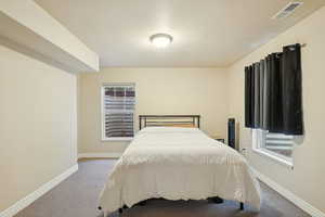 Carpeted bedroom featuring baseboards