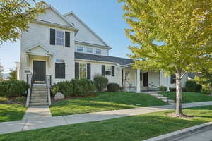 Traditional-style house featuring a front yard