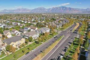 Aerial view of property and surrounding area with mountains and nearby suburban area