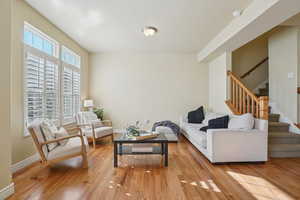 Living area featuring stairway and light wood finished floors
