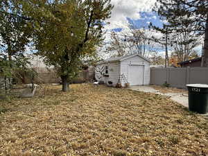 Fenced backyard with an outdoor structure