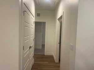 Corridor with dark wood finished floors and baseboards