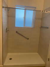 Full bathroom featuring a tile shower