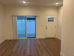 Entrance foyer featuring dark wood finished floors and recessed lighting
