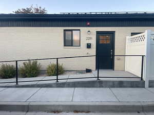 Property entrance featuring brick siding