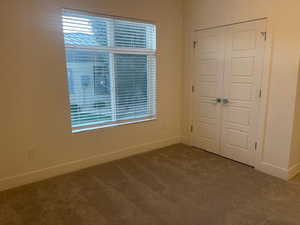 Unfurnished bedroom with a closet and carpet floors