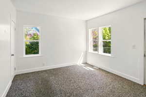 Carpeted empty room featuring plenty of natural light