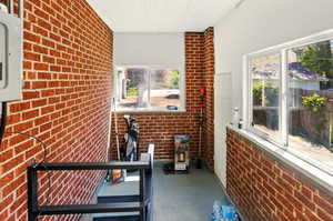 Unfurnished sunroom with electric panel