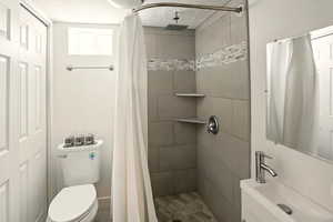 Bathroom with a shower stall, a textured ceiling, and vanity