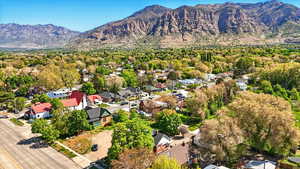 Aerial overview of property's location featuring nearby suburban area and a mountainous background