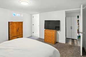 Carpeted bedroom featuring baseboards