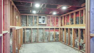 Unfinished basement space, with already framed walls providing storage space or room to grow!