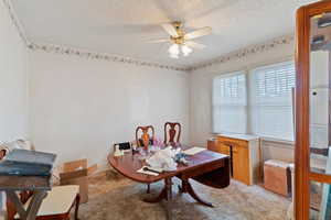 Dining room with a textured ceiling and a ceiling fan
