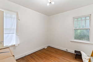 Spare room with baseboards and light wood-style flooring