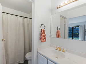 Bathroom featuring vanity and curtained shower