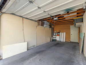 Detached garage with a man door leading to the property courtyard and front door of the unit.