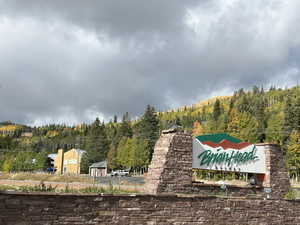 Community sign featuring a view of trees