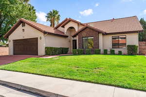 Mediterranean / spanish house with stucco siding, an attached garage, driveway, and a tiled roof