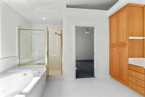 Full bathroom featuring a shower stall, a garden tub, light tile patterned floors, ceiling fan, and recessed lighting