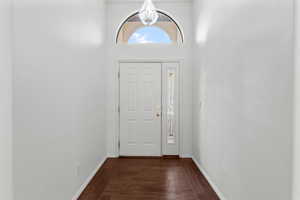 Entryway featuring dark wood finished floors and baseboards