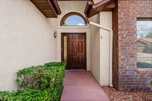 Doorway to property with stucco siding