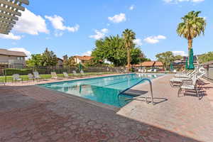 Community pool with a patio and a pergola