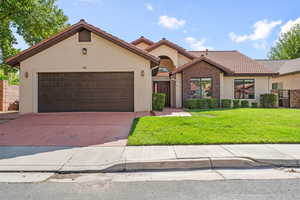 Mediterranean / spanish-style house featuring stucco siding, concrete driveway, a tiled roof, and an attached garage