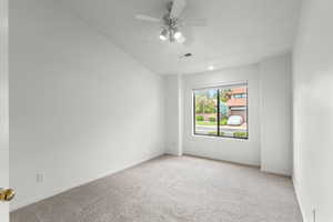 Empty room featuring carpet and a ceiling fan