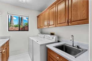 Laundry area with cabinet space and washer and clothes dryer
