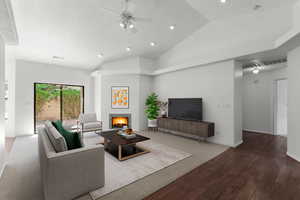 Virtually staged, Living area with wood finished floors, a warm lit fireplace, ceiling fan, lofted ceiling, and recessed lighting