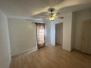 Unfurnished bedroom with light NEW LVP flooring and ceiling fan