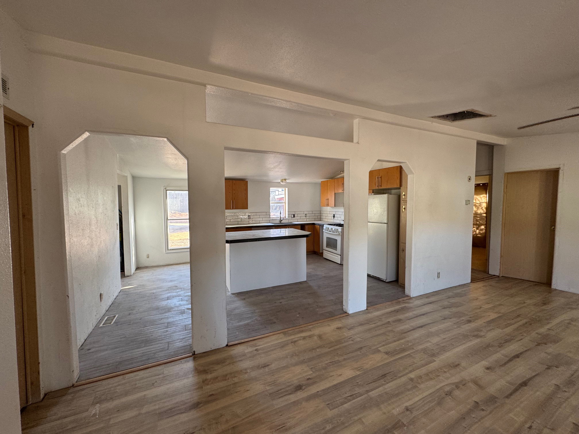 Open floor plan, NEW LVP floors, and white appliances