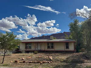 View of front of home with a mountain view and a porch