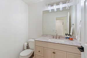 Bathroom featuring vanity and toilet