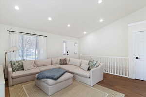 Living area featuring lofted ceiling, wood finished floors, and recessed lighting