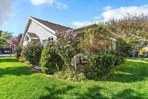View of side of property featuring a yard and a patio area
