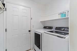Laundry room featuring washer and clothes dryer