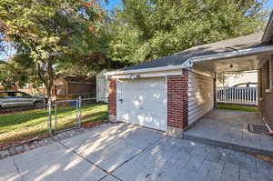 Garage, covered patio, and side yard.