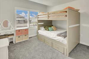 Bedroom featuring carpet floors and baseboards