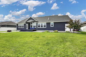 Back of property with a patio area, a shingled roof, and stucco siding
