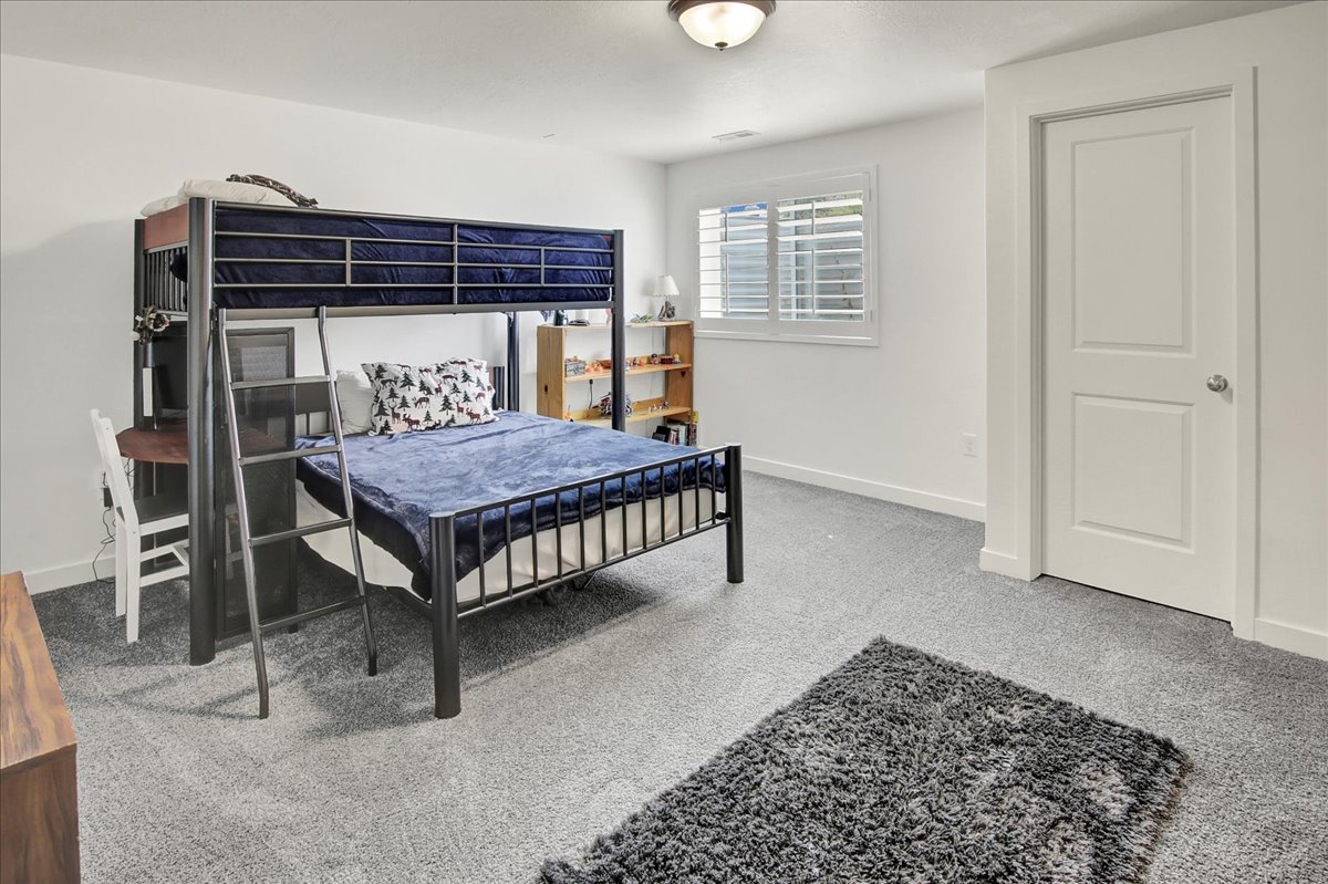Carpeted bedroom with baseboards