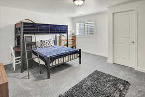 Carpeted bedroom with baseboards
