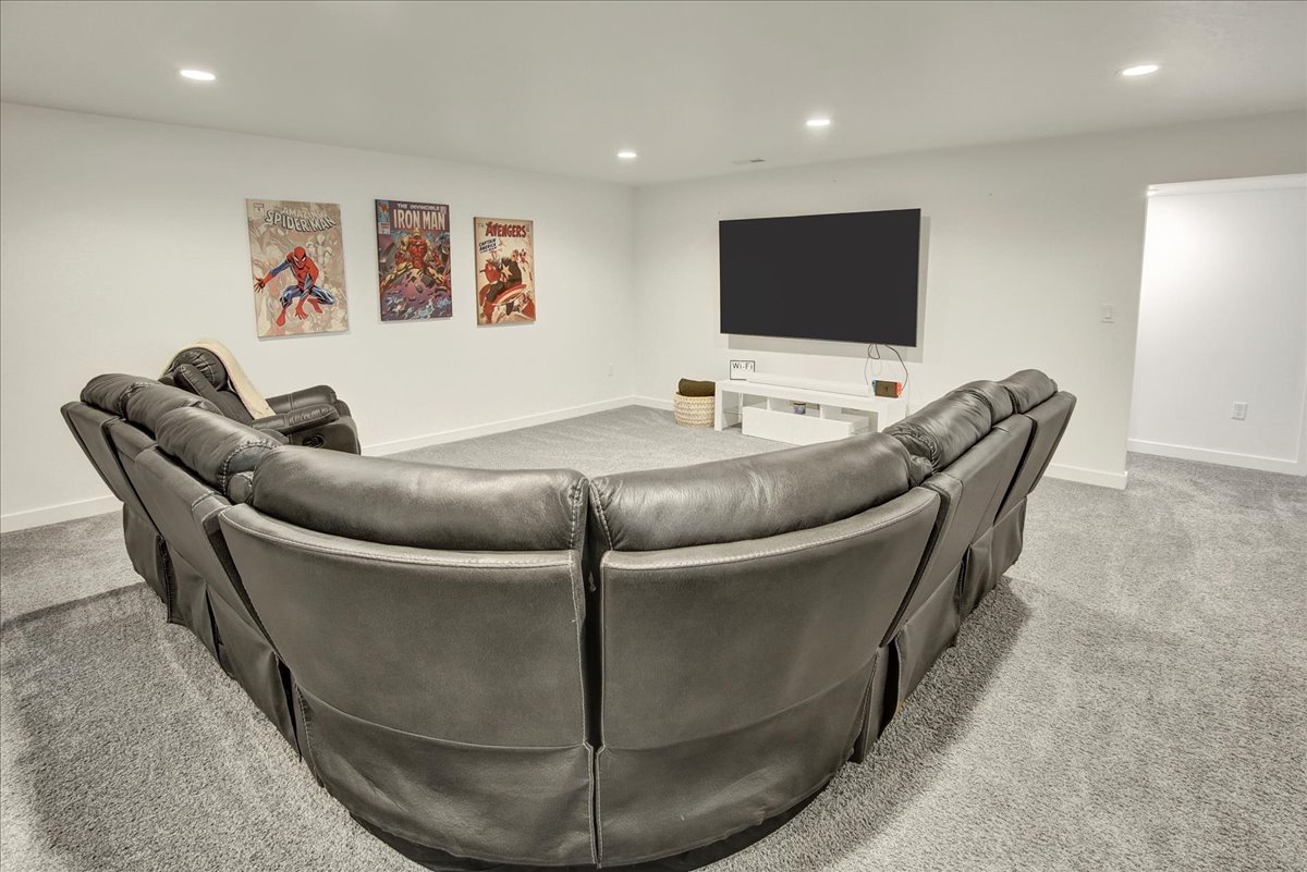Living room with recessed lighting and light colored carpet
